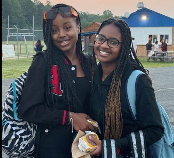 Two girls grab breakfast at the senior sunrise.