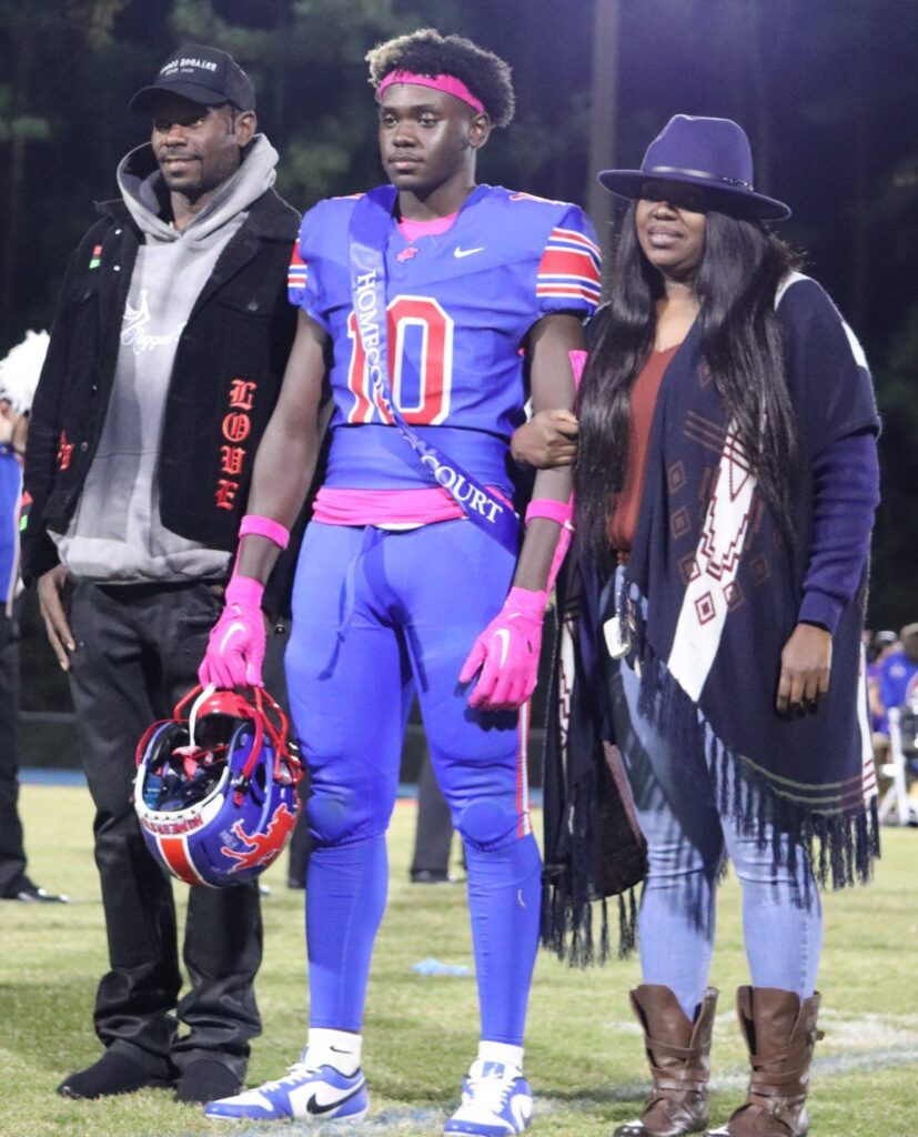 homecoming court member escorted in