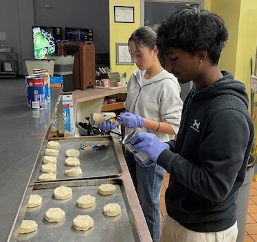 Beta Club members prepare biscuits and cinnamon roles.